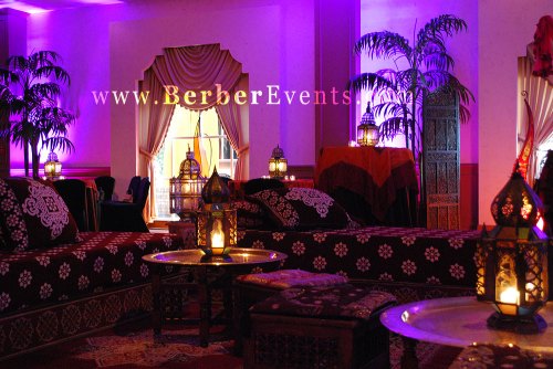 Authentic & Comfortable Moroccan Lounge Furniture and Lanterns in a fushia color wall wash